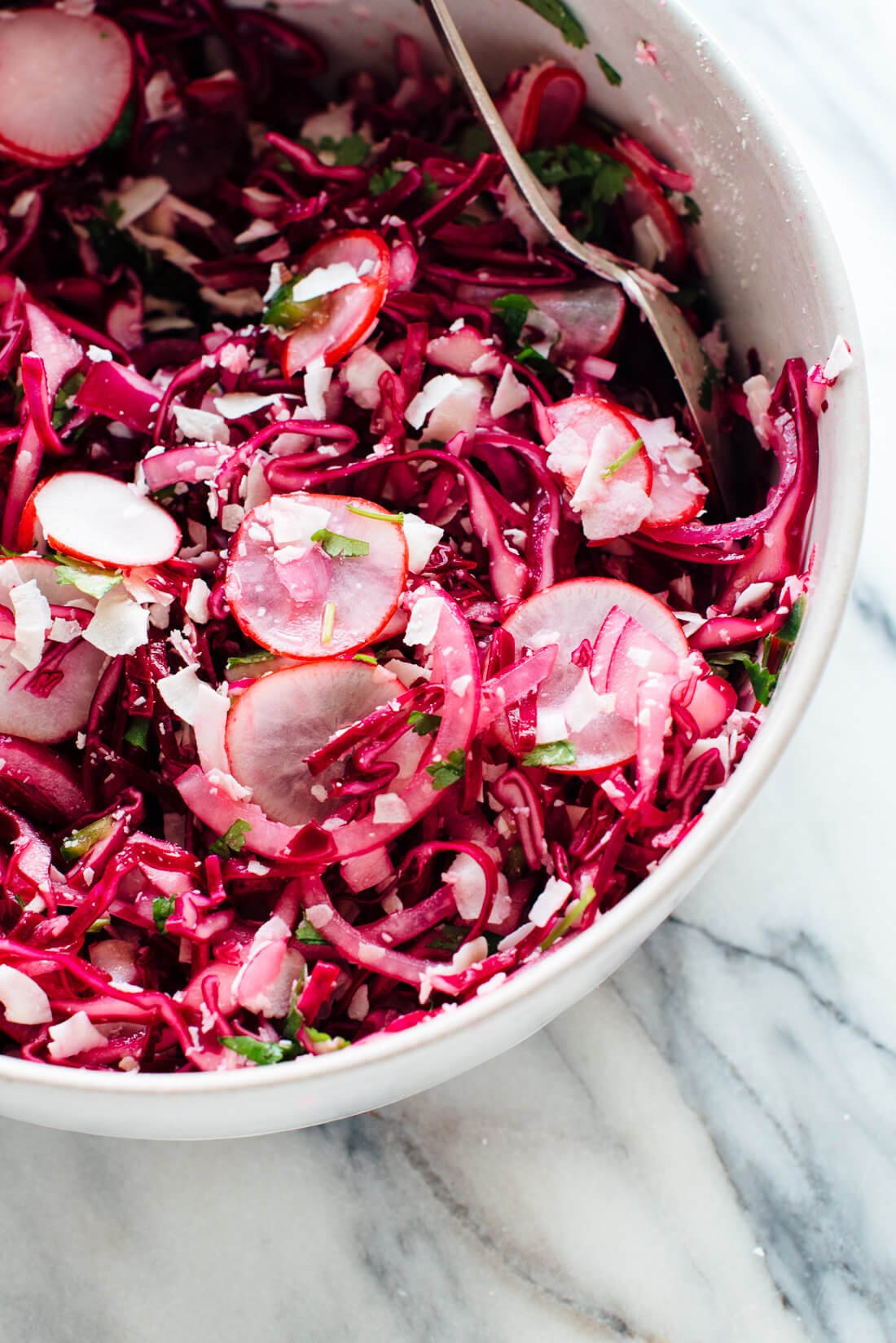 This hot pink slaw is totally irresistible, thanks toโsurpriseโcoconut! If you like coconut, you're going to love this nutrient-dense slaw/side salad. cookieandkate.com