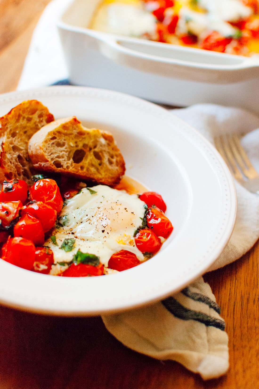 Baked Eggs on a Bed of Roasted Cherry Tomatoes in bowl
