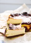 slice of Basque cheesecake next to cheesecake