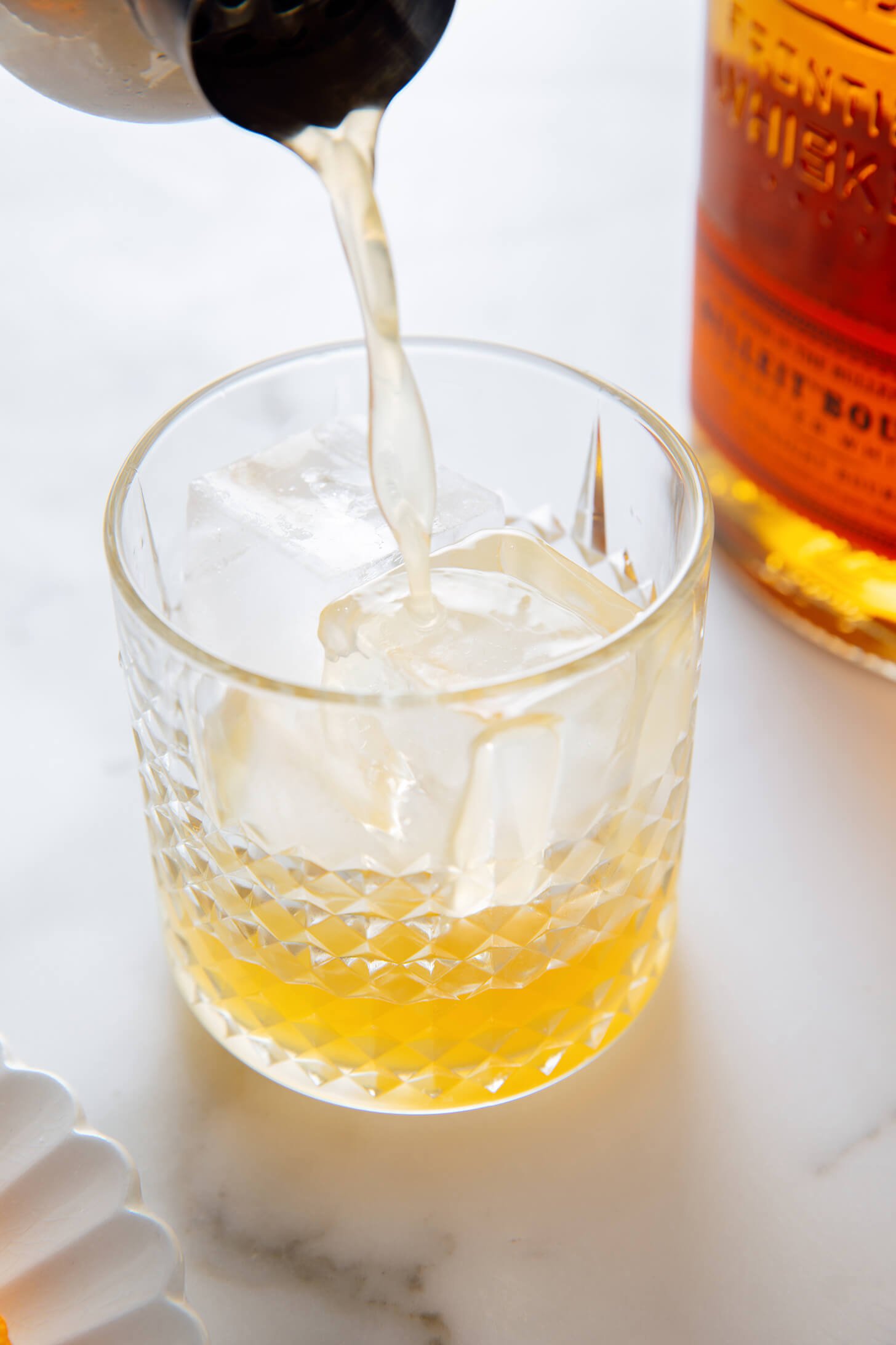 pouring whiskey sour