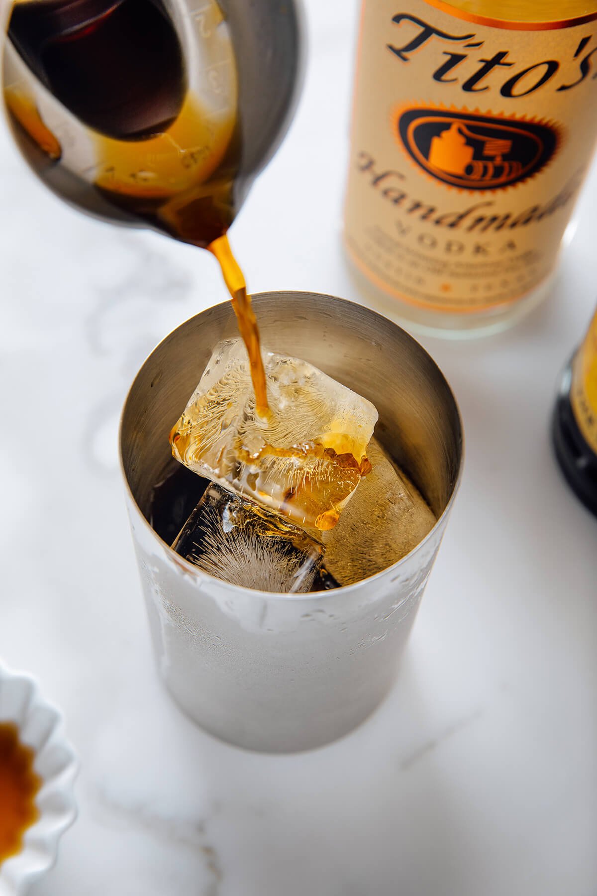 pouring coffee into cocktail shaker