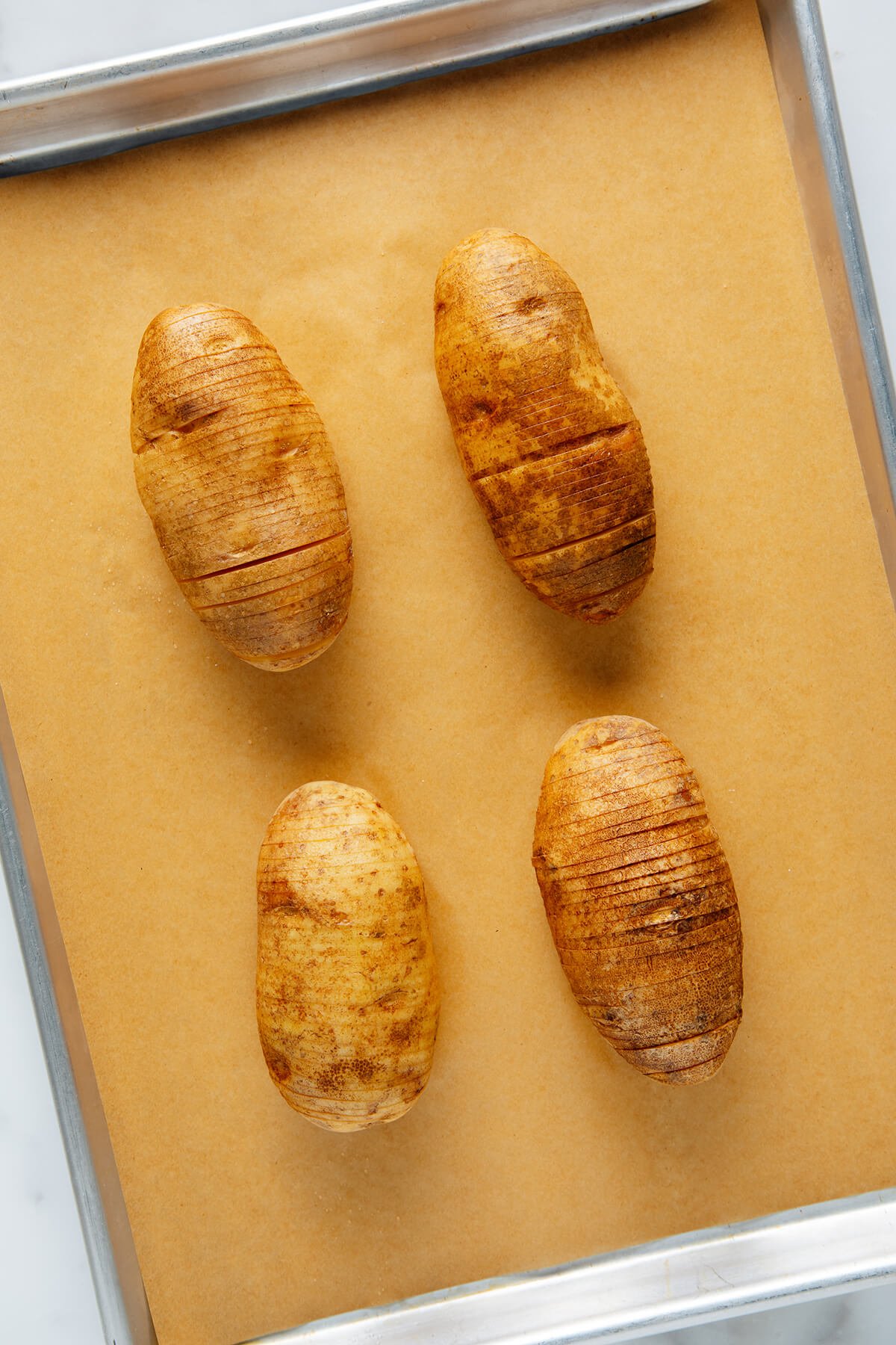 Hasselback potatoes before baking