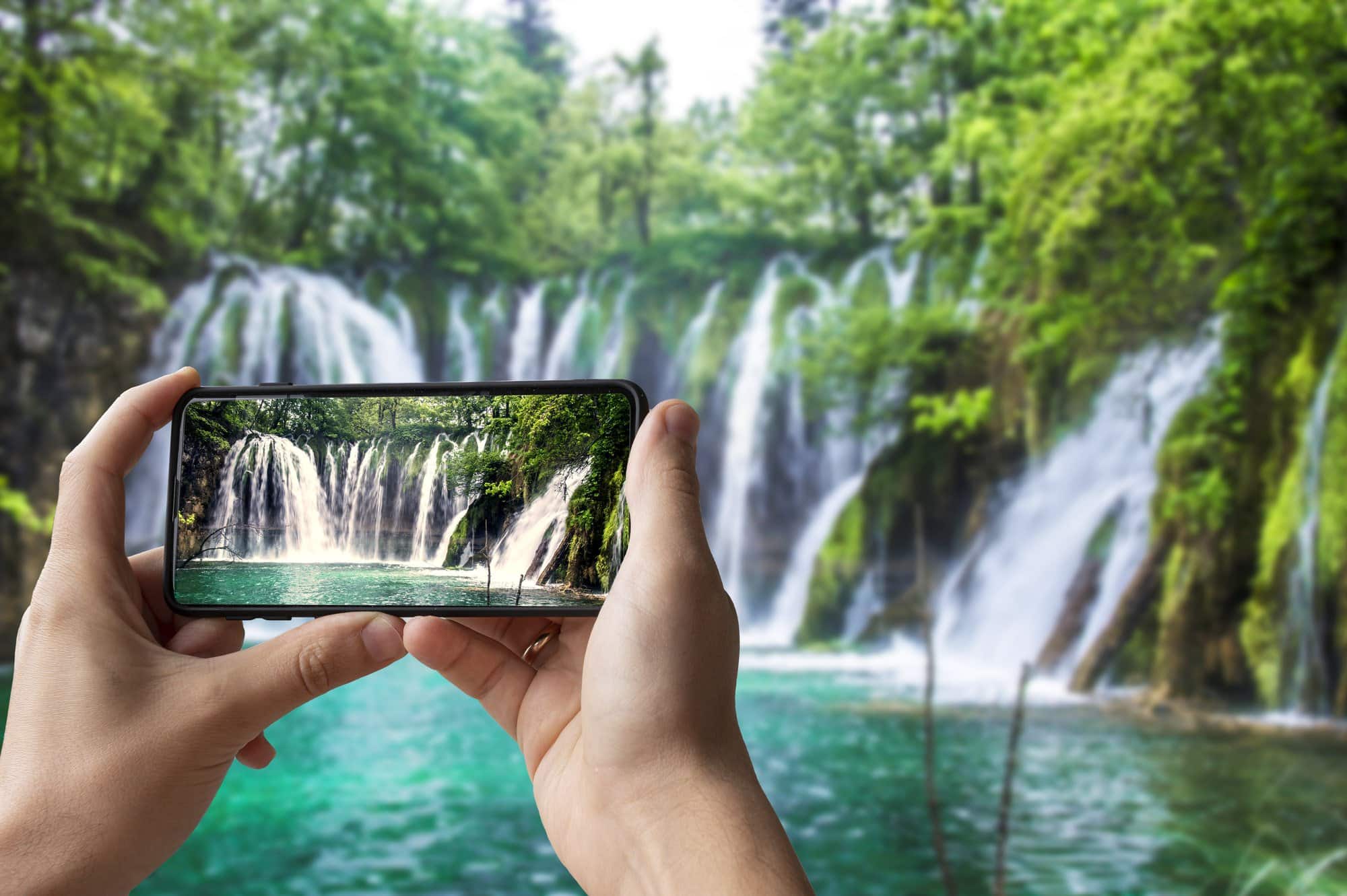 how to live your best life taking a picture of a waterfall