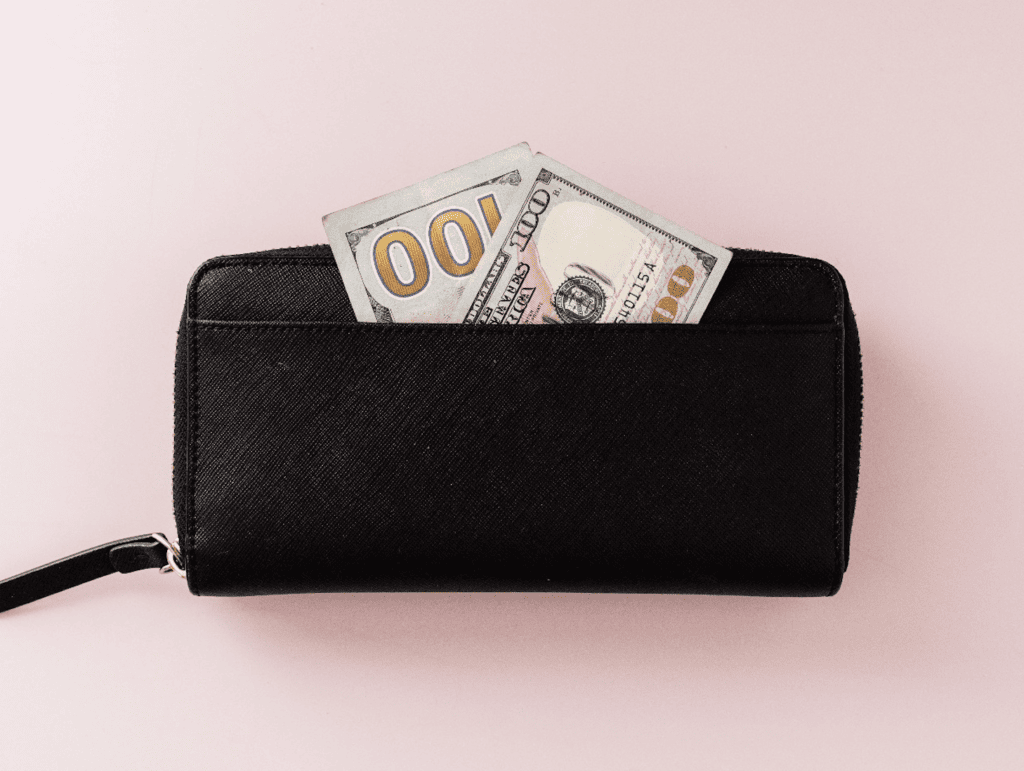 $100 bill in wallet. A No Spend Challenge Can Reset Your Finances – Here’s How To Do It
